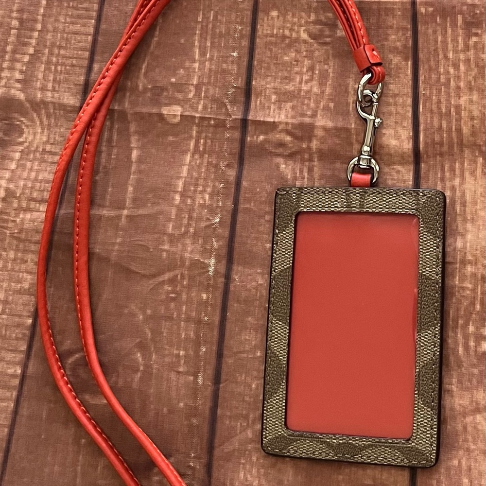 Coach gold and orange ID lanyard.